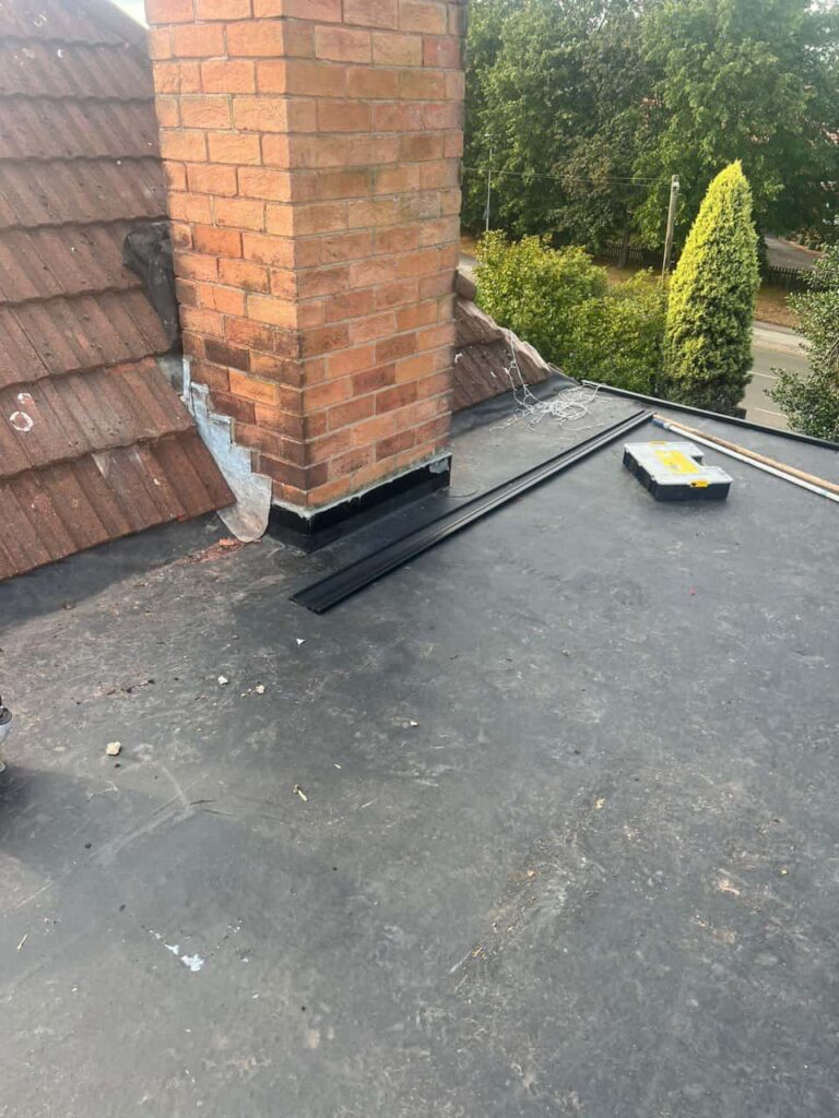 This is a photo of a flat roof which has just been repaired, there is also a chimney stack and some leadwork has also been dressed. Works carried out by Castle Donnington Roofing Repairs